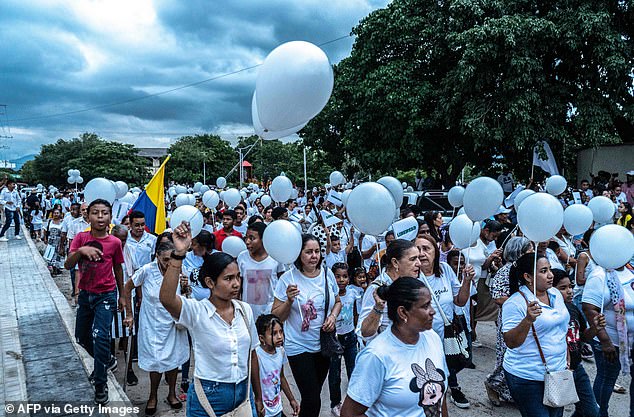 Hundreds of local community members joined forces, dressed in white balloons and held them