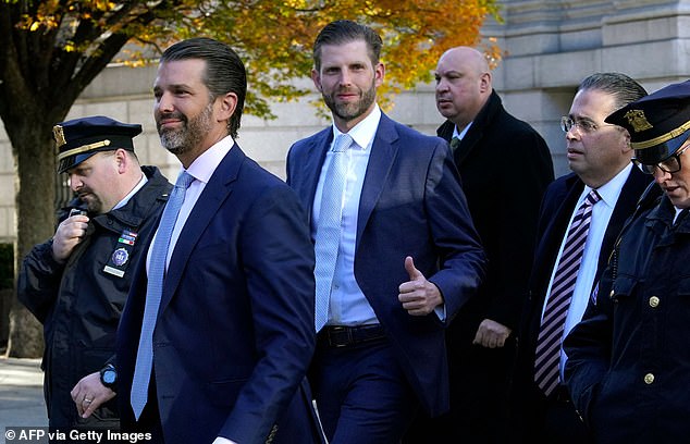 Eric Trump gives a thumbs up before taking his stand