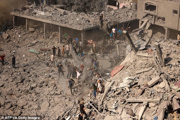 People check buildings destroyed on November 2 during an Israeli attack on the Bureij refugee camp in the central Gaza Strip