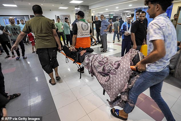 A victim injured in an Israeli bombing is carried on a stretcher at Al-Shifa Hospital in Gaza City on November 2