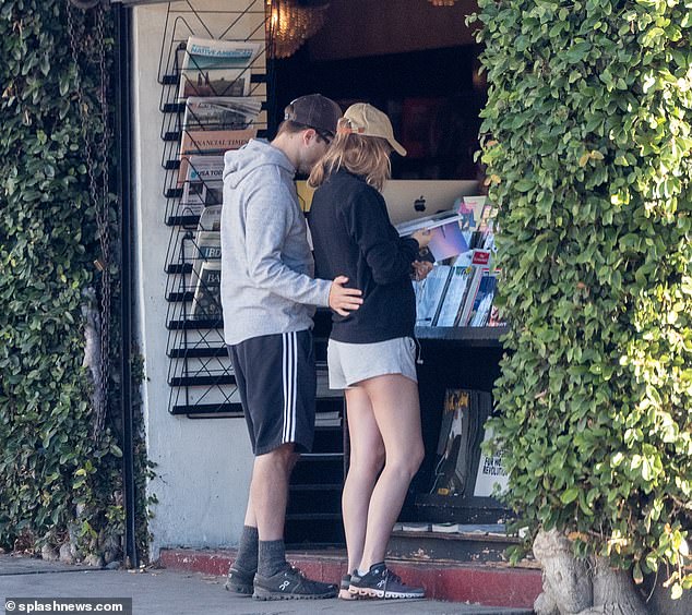 In love: The power couple was quite in love as Robert wrapped his arms around his lover while Suki was browsing through one of the publications