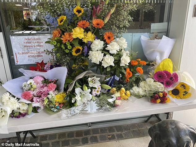 Flowers and cards have been collected outside the school as the community copes with the tragedy