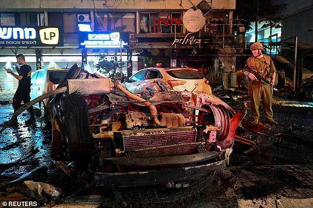 Israeli police inspect the scene of a rocket attack in the Israeli border town of Kiryat Shmona, Israel on Thursday