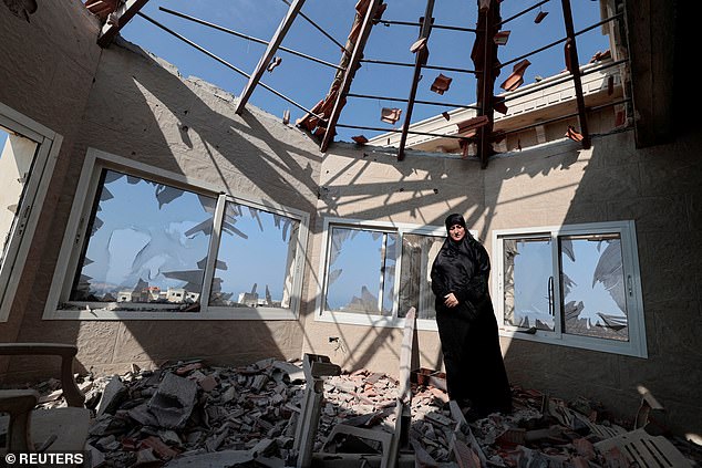 Chadia Kaddouh stands Wednesday amid the rubble of her home destroyed by what she said was Israeli shelling in the southern city of Yater, Lebanon