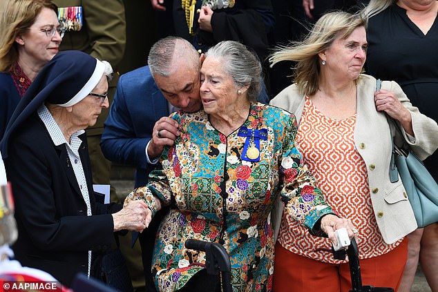 Dallas Hayden (center, wife of Bill Hayden) and daughter Georgina (right) are seen at the funeral of their late husband and father