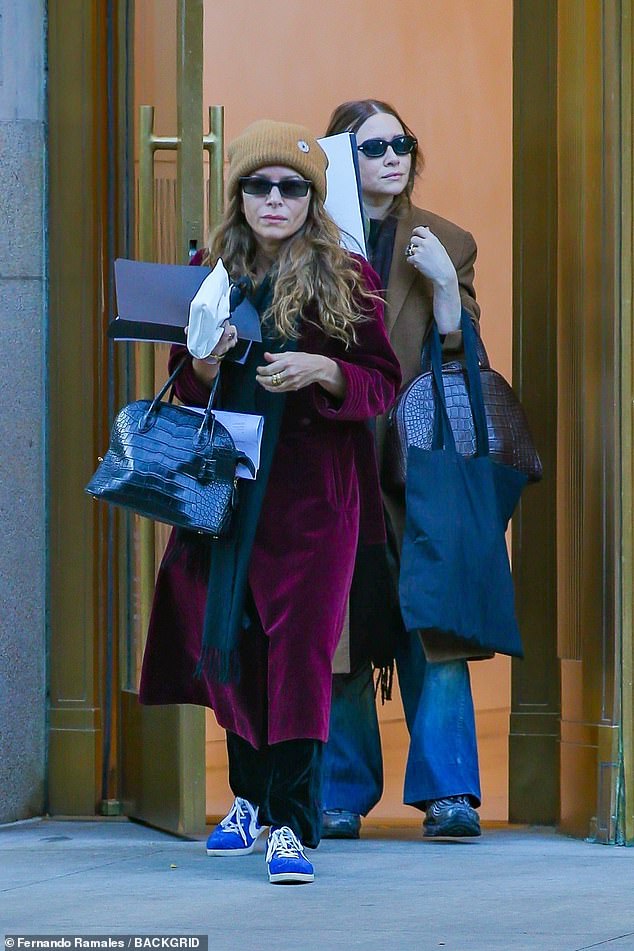 Style: Ashley looked stylish in a cozy tan coat, flared blue jeans and a dark brown scarf draped around her neck