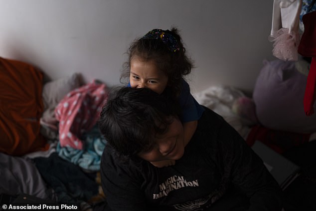 Sánchez plays with Jennifer on the bunk bed they share in a shared studio apartment