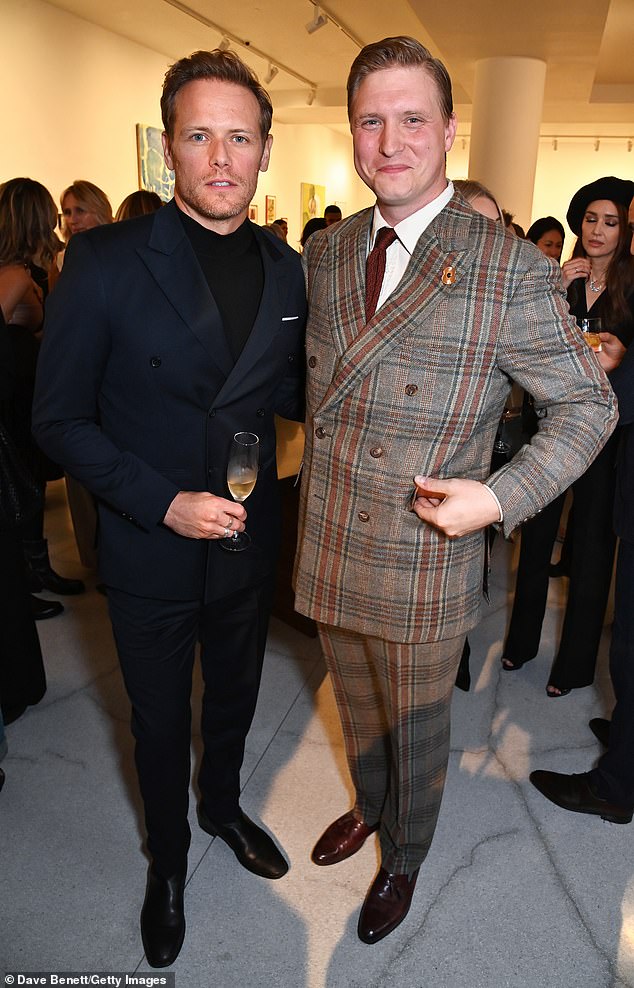 Chipper: Sam Heughan and Tom Chamberlin looked in good spirits as they attended the party