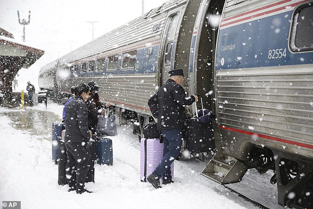 Last week, a storm moved out of the Pacific Northwest, covering the area from Montana to North Dakota with nearly a foot of snow and bringing cold air south (Photo: Conductor helps passengers board the southbound Amtrak Vermonter in Waterbury , Virginia, during a snowstorm on Tuesday, March 14, 2023)