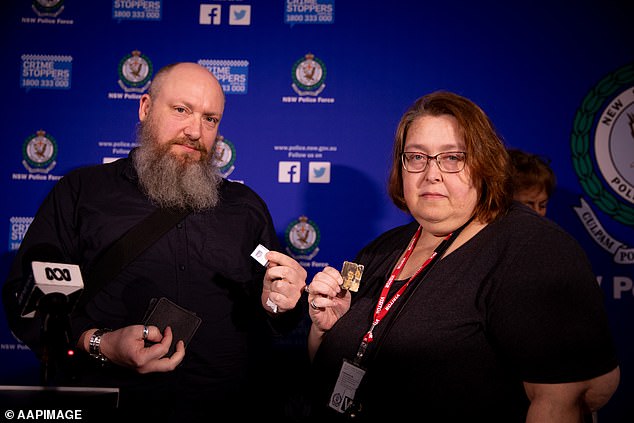 Phillip and Tahli Govendir show photos of their mother during a press conference