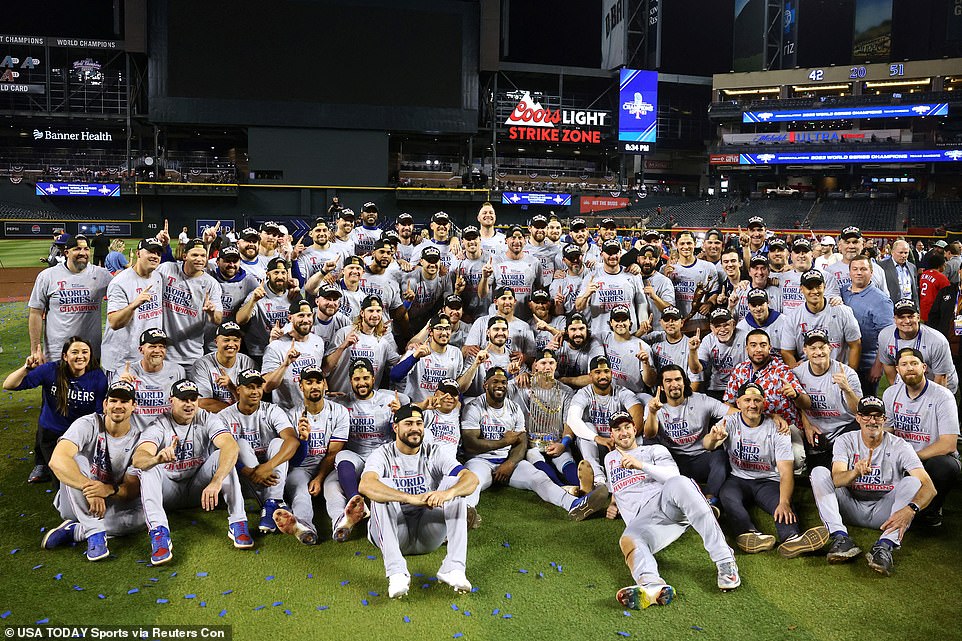 The Rangers pose for a team photo after beating the Arizona Diamondbacks 5-0, and in Game 5 and in five games overall