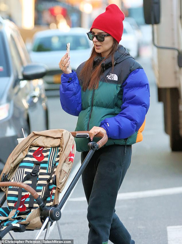 Staying warm: The fashion industry mainstay, who was recently spotted during a steamy makeout session in Paris, wore a multi-colored North Face puffer jacket contrasted with black Danzy sweatpants