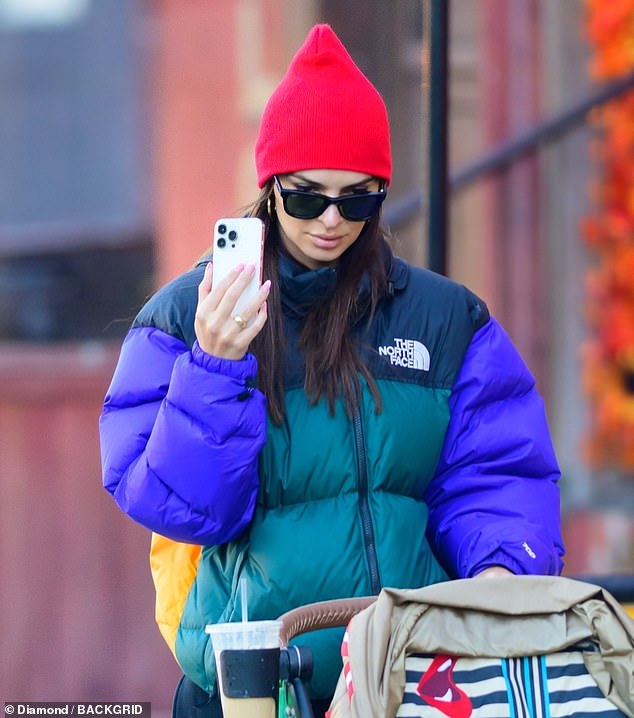 Beautiful: Much of the entrepreneur's gorgeous brunette hair was covered by a red cap, although several strands fell to her shoulders and chest