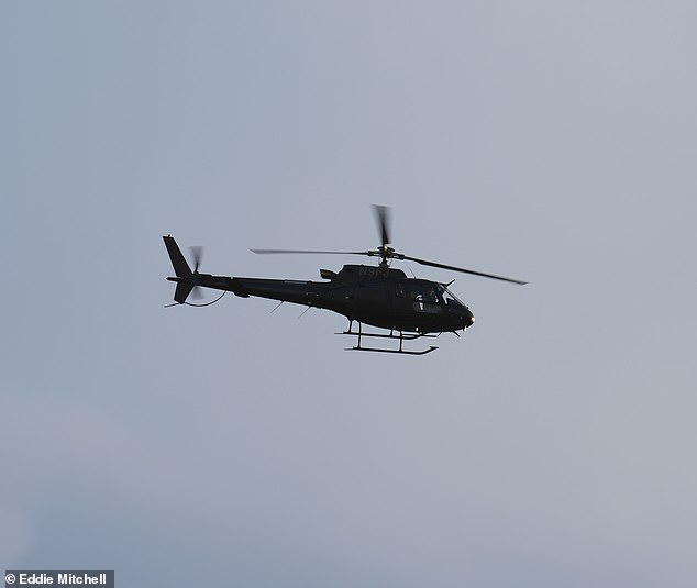 The actor was filmed flying away in a black helicopter from the headquarters in East Grinstead