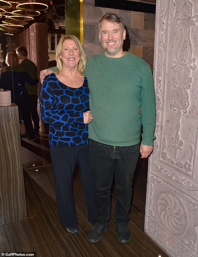 Cute: Spencer cut a casual figure in black jeans and a green sweater as he posed with his mother