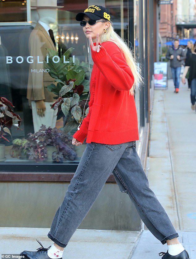 Good vibes: The 28-year-old supermodel flashed a peace sign as she cut a casual figure as she walked through the city streets