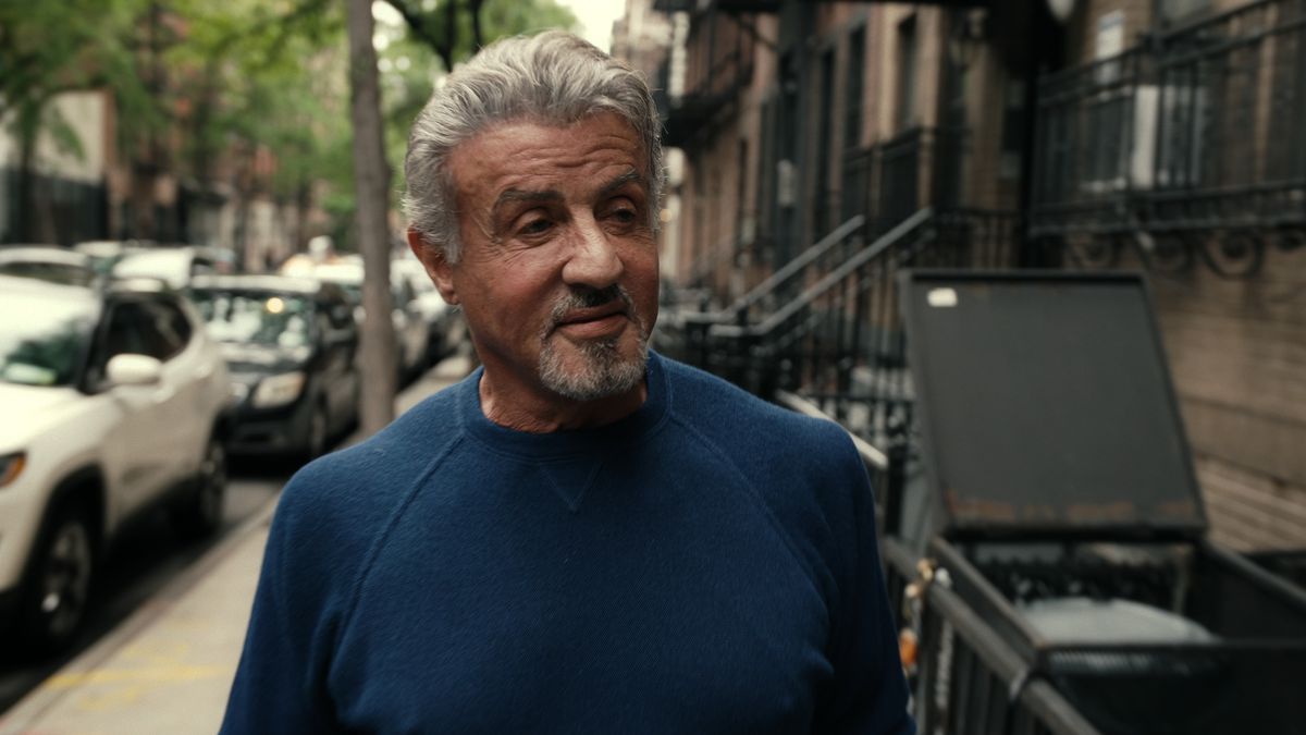 Sylvester Stallone walks through a neighborhood in Sly.