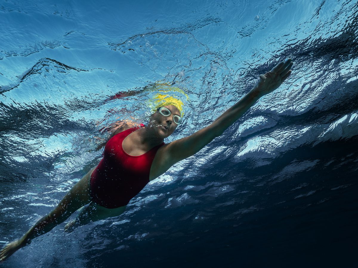 Annette Bening as Diana Nyad, swimming in the ocean in Nyad.