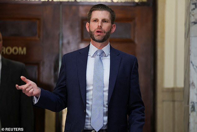 The son of former US President Donald Trump and co-defendant Eric Trump talks to the media outside the courtroom on Friday