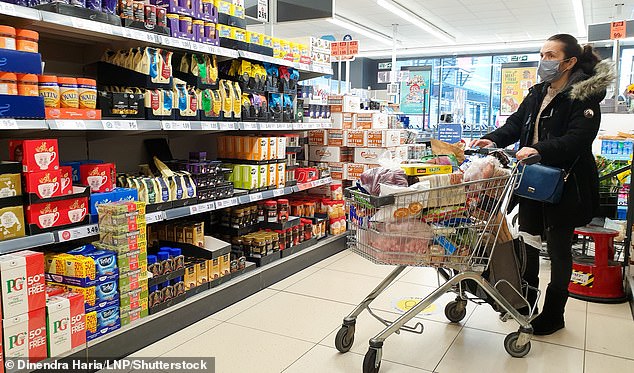 A customer filling his shopping cart at a Lidl supermarket in North London in January 2021