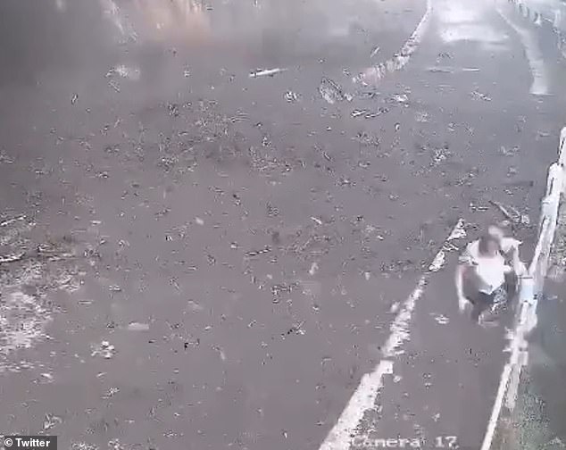 A woman runs away from El Peñón de Guatapé moments after a landslide at the iconic monument in Guatapé, Colombia, which injured 17 people, including two minors