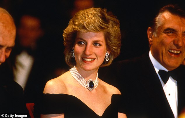 The Princess of Wales wears a midnight blue velvet off-the-shoulder evening dress designed by Victor Edelstein as she attends a state banquet in April 1986 in Vienna, Austria