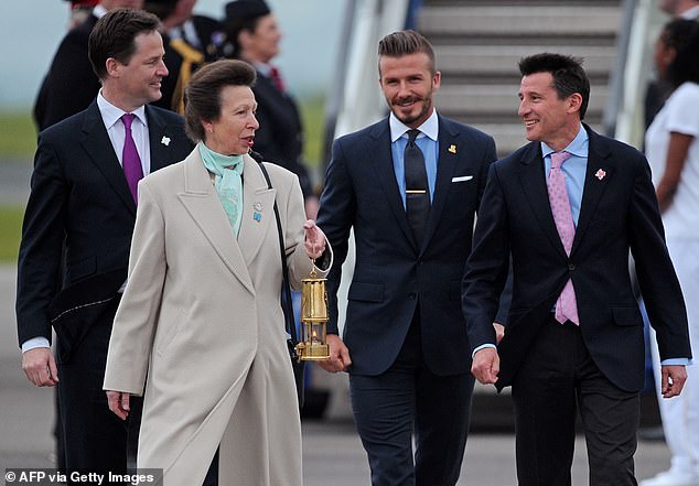 Princess Anne arrives with the Olympic flame, accompanied by David Beckham and Sebastian Coe