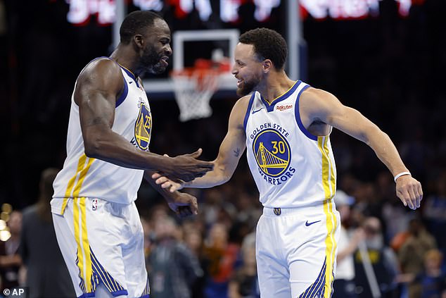 Golden State Warriors' Draymond Green, left, and Stephen Curry celebrate the victory