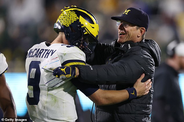 Michigan Wolverines head coach Jim Harbaugh congratulates JJ McCarthy (left)