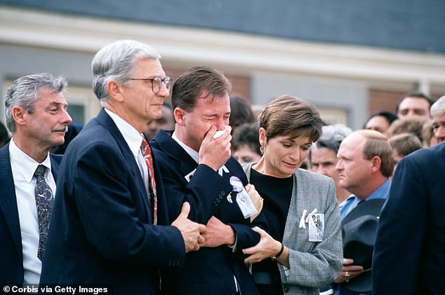 David Smith, father of the boys, leaves the church after the funeral service for the two young boys