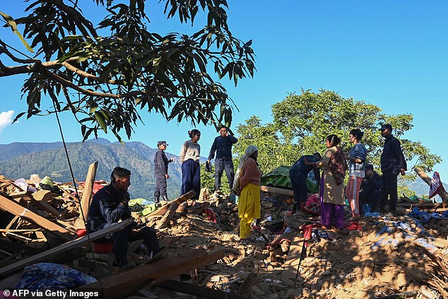 Locals frantically dug through the rubble in the dark to pull survivors from the rubble of their collapsed homes