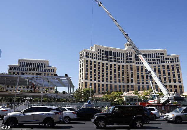 Vehicles pass a Formula 1 construction site at the Bellagio Fountains on Monday, September 25, 2023