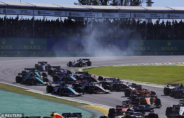 The Brazilian Grand Prix sprint race in action on the opening lap, as smoke rises to the sky