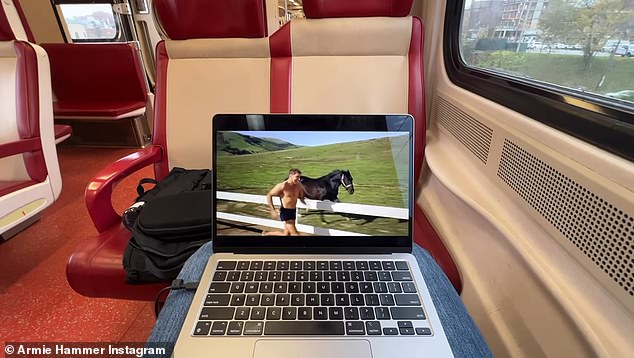 Return: He appeared to be on a train with a laptop on his lap as a clip from the 1968 mystery film The Swimmer played on the computer