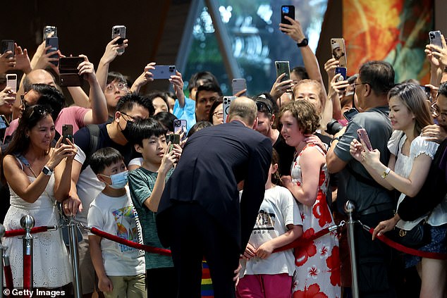 William chatted with children and took selfies with those eagerly lining the airport as he walked with Sim Ann, the country's foreign minister