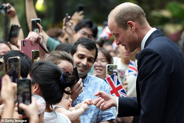 The Prince of Wales arrived at Changi Airport on Sunday to cheering crowds holding aloft signs, waving Union Jack flags and holding photos of his late mother, Princess Diana.