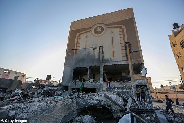 People search buildings destroyed during Israeli airstrikes in the southern Gaza Strip on November 5, 2023 in Khan Yunis, Gaza