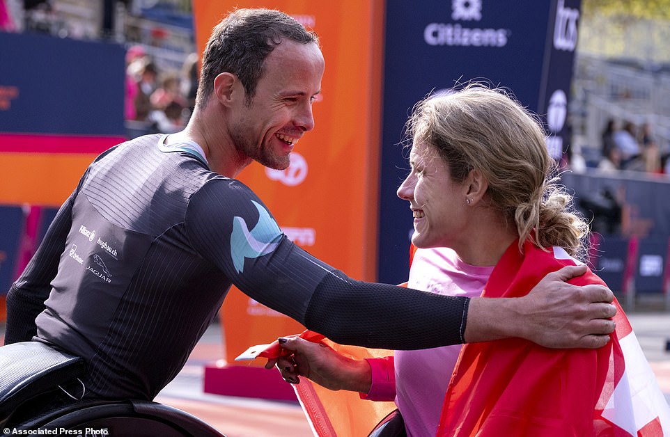 Catherine Debrunner of Switzerland, who won the women's wheelchair division of the NYC Marathon, gets a hug from Hug