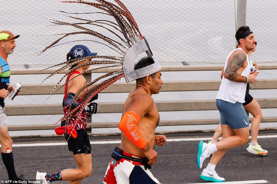 A runner wears a Mexican native head decoration as he crosses the Verrazano Bridge on a cool and sunny Sunday in New York