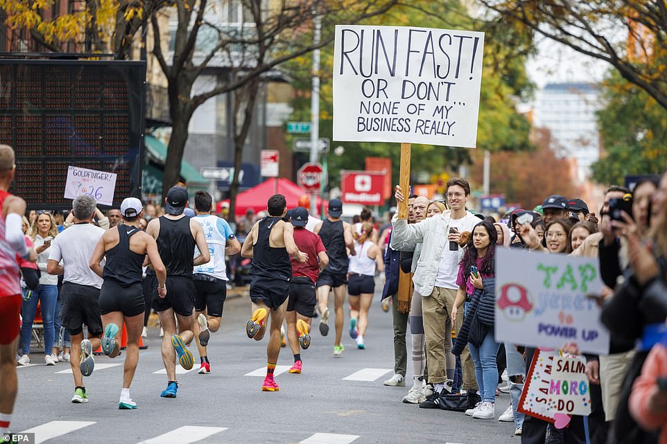 A spectator with a hilarious sign was all smiles as he cheered on amateur athletes running the NYC Marathon in Brooklyn