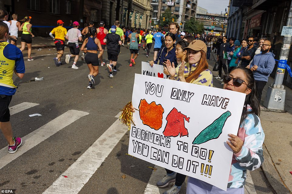 Another spectator held a poster teasing runners and letting them know the size of the boroughs they have to run through