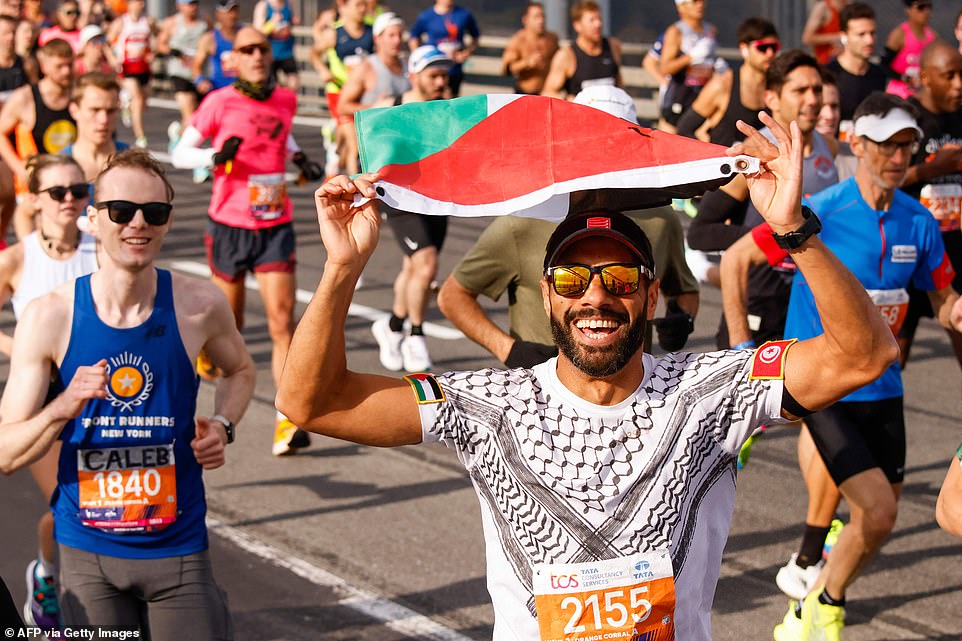 A runner was all smiles while holding a Palestinian flag as he crossed the Verrazano Bridge on a beautiful day in the Big Apple