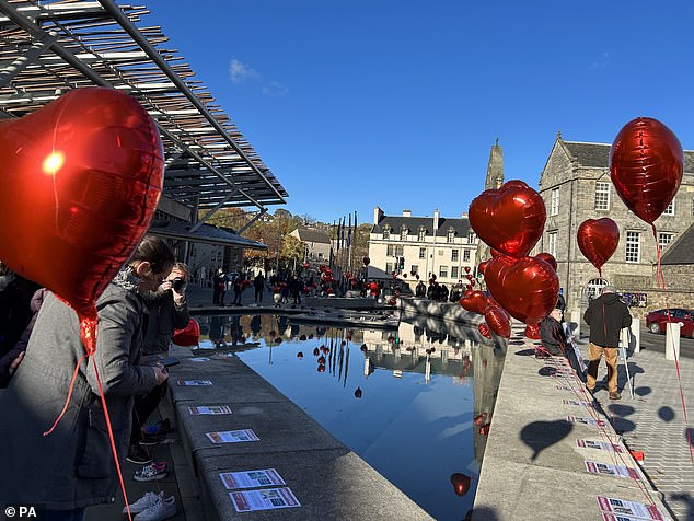 Heart-shaped balloons were tied to shoes to represent each of the hundreds of people believed to have been kidnapped