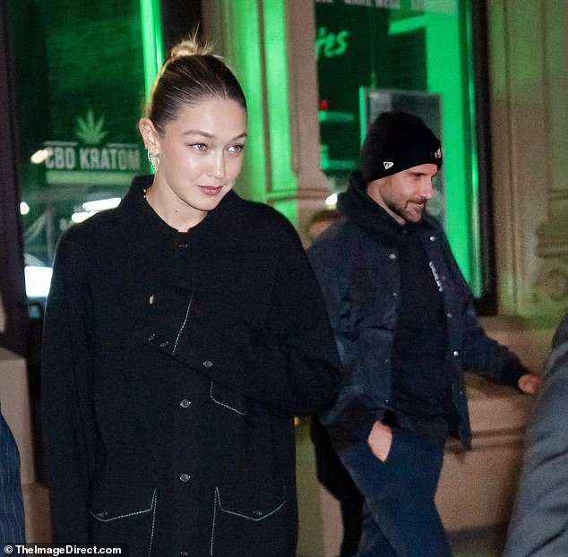 Stunner: Gigi looked sensational in a black Oxford shirt dress, glancing off her statuesque figure as she left the famous address