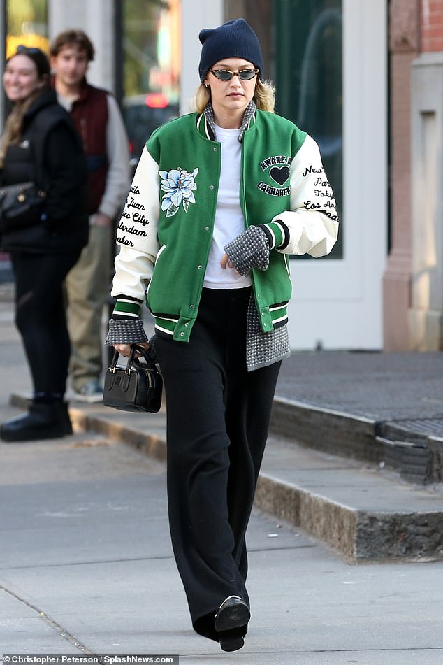 Varsity chic: The next day Gigi was seen in New York wearing a varsity jacket and a Miu Miu bowling bag