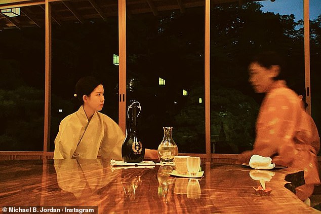 Having a drink: One photo showed some of his dining companions, two women in kimonos chatting at a low wooden table around what appeared to be a bottle of sake and appropriately small cups