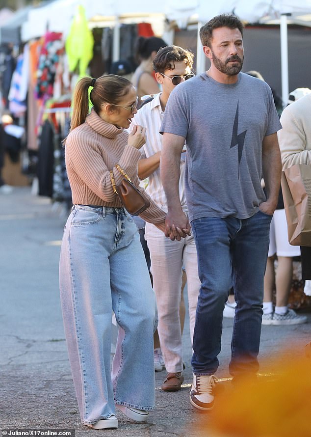 Casual cool: Meanwhile, the director wore a casual gray T-shirt with a lightning bolt motif