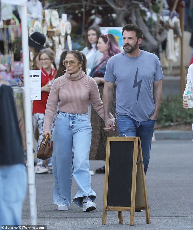 Trendy: He completed his look with blue jeans and colorful Nike sneakers