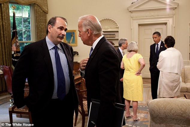 In 2009, Vice President Joe Biden speaks with senior adviser David Axelrod during a meeting in the Oval Office