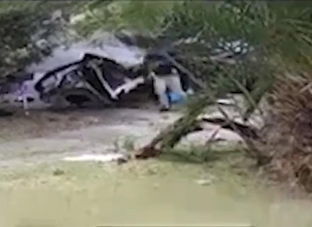CCTV footage has emerged showing the adult driver picking up the body of one of the dead boys from the wreckage before dumping it on the ground.